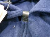 a blue jacket with a tag attached to it