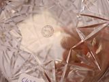 someone is holding a clear glass bowl with a star on it