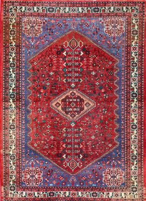 a red and blue rug with an ornate design