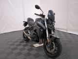 a motorcycle that is parked in a room with a checkered floor