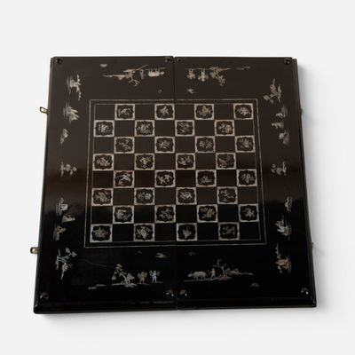 a picture of a black and white chess board on a white surface