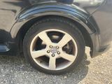 a close up of a car ' s tire on the road