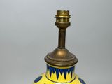a yellow and blue vase sitting on a table