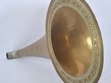 an old brass trumpet with a decorative design on the side
