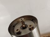 a metal cup that is sitting on top of a table