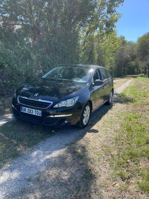a picture of a black car parked on a dirt road