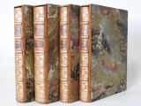 three books are stacked on top of each other on a white surface