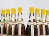 several bottles of wine are lined up on a table