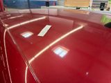 a remote control on the hood of a red car