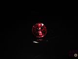 a close up of a red diamond on a black surface