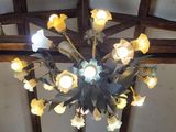 a chandelier made of flowers hanging from the ceiling
