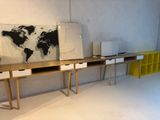 an image of a desk with a world map on the wall