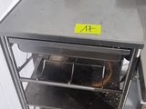 a small oven that is sitting in the corner of a kitchen