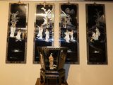 four framed pictures on the wall above a chair