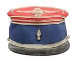 a red and blue hat with a gold medal on it