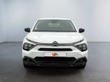 the front view of a white car in a white room
