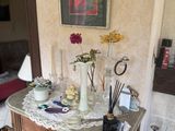 a small table with a vase on top of it in a room