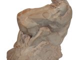statue of a woman sitting on a rock on a white background
