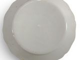 a white plate with a gold rim on a white surface