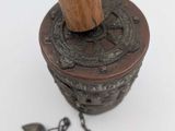 a wooden stick sticking out of a metal container