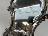 a mirror that is hanging on a wall in a room