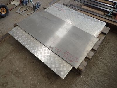 several pieces of steel are stacked on pallets in a warehouse