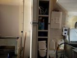 a tall cabinet with a door open in a kitchen