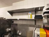 a small kitchen with a stove, sink, microwave and other appliances