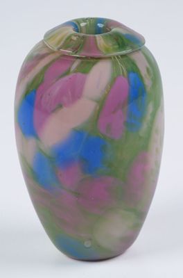 a colorful vase with a lid sitting on a white surface