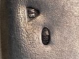 a close up of a metal object with a face on it
