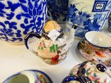 many different types of teapots and cups on the table