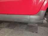 a close up of a red car with a flat tire