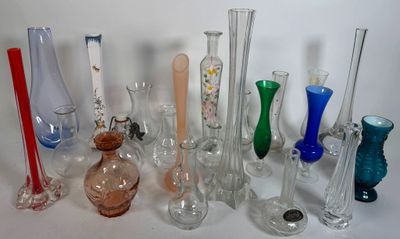many different colored glass vases sitting on a table