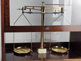 a scale that is sitting on a shelf with a clock on it