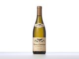 a bottle of white wine sitting on top of a table