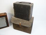 two old suitcases sitting next to each other on a white surface