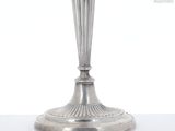 a silver candle that is sitting on a table