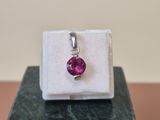 a close up of a ring with a pink stone in it