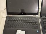 two laptops sitting side by side on a table