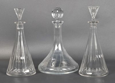 three clear glass vases sitting next to each other on a table
