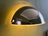 an image of a wall mounted lamp on a green wall