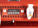 a close up of a red car dashboard with a vase on it