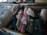 many bags of luggage sitting on a shelf in a room