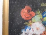 a painting of flowers in a gold frame on a wall