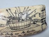 an elephant tooth with a drawing of a boat on it