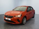 the orange car is parked in a large room