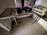 a dog that is laying on a table in the kitchen