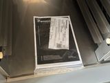a newspaper sitting on top of a stove in a kitchen