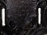 a close up of a black iron door handle on a white wall