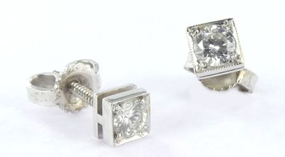pair of diamond stud earrings on a white background
